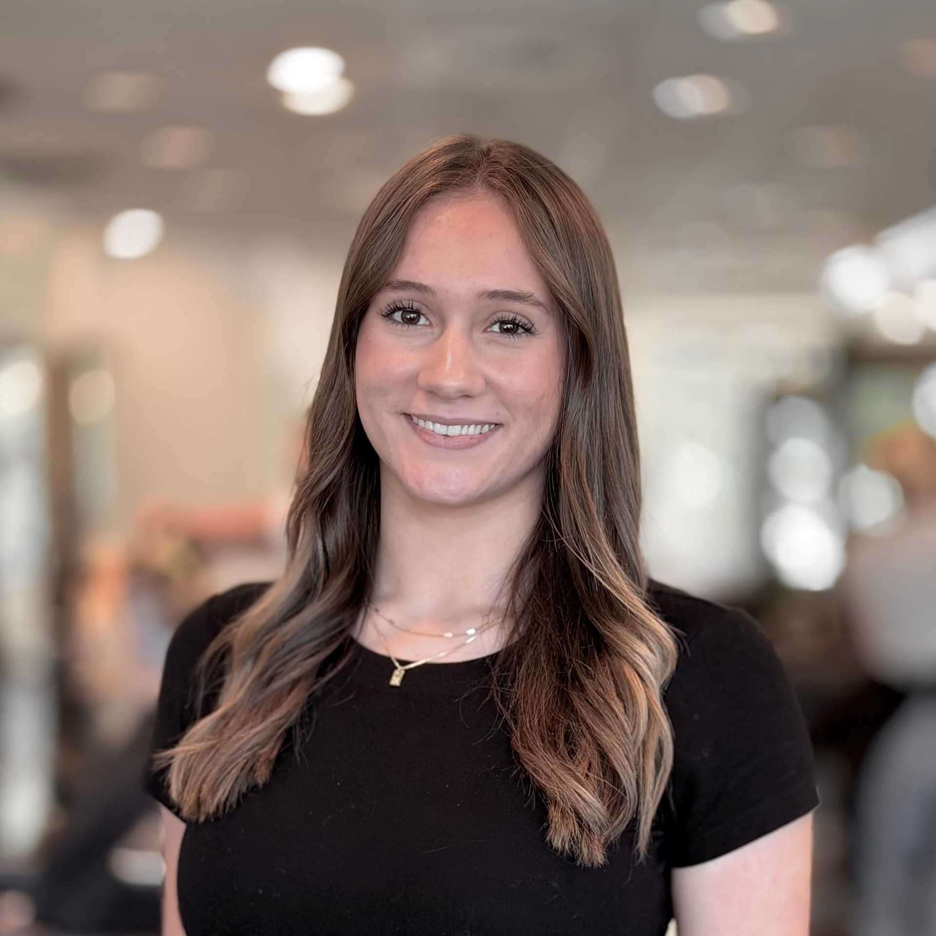 Portrait of Whitney, a professional stylist at Brassfields Salon and Day Spa, showcasing their expertise and style.
