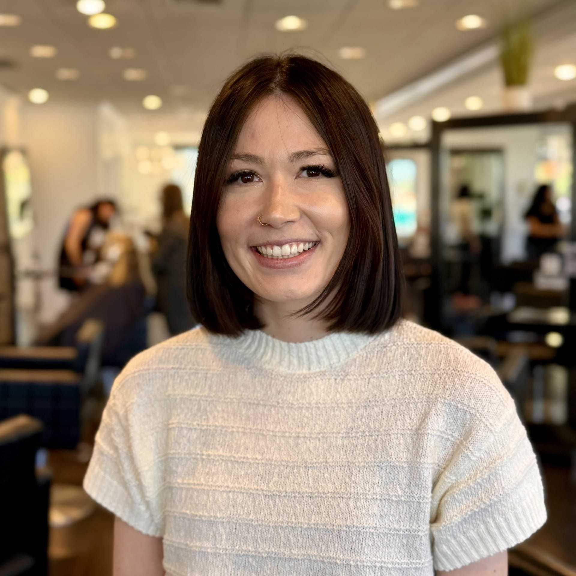 Portrait of Kenzie, a professional stylist at Brassfields Salon and Day Spa, showcasing their expertise and style.