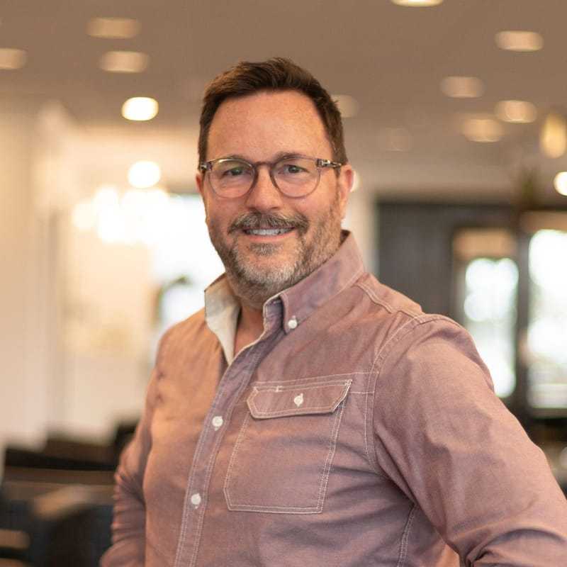 Portrait of Michael, a professional stylist at Brassfields Salon and Day Spa, showcasing their expertise and style.