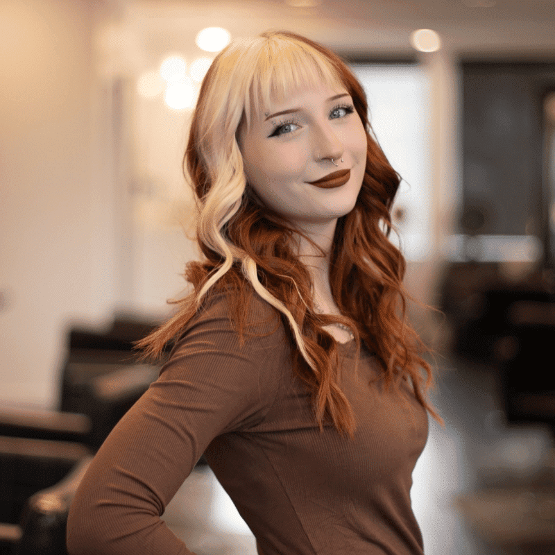 Portrait of Izzy, a professional stylist at Brassfields Salon and Day Spa, showcasing their expertise and style.