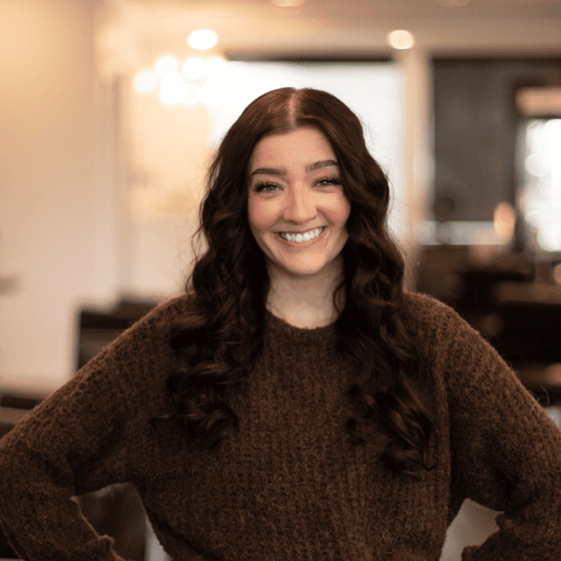 Portrait of Tyrah, a professional stylist at Brassfields Salon and Day Spa, showcasing their expertise and style.