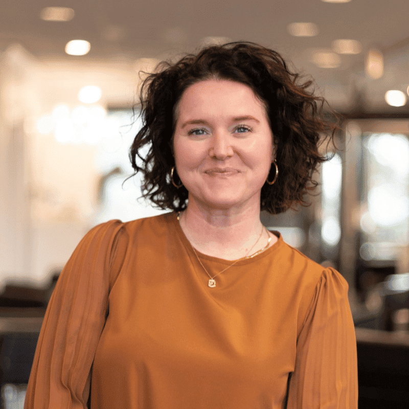 Portrait of Amy, a professional stylist at Brassfields Salon and Day Spa, showcasing their expertise and style.