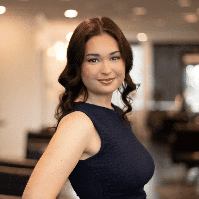 Portrait of Jenny, a professional stylist at Brassfields Salon and Day Spa, showcasing their expertise and style.