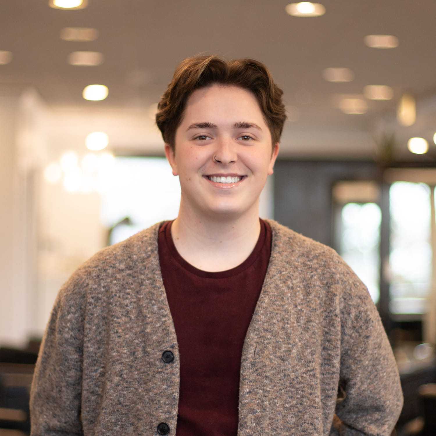 Portrait of Jairus, a professional stylist at Brassfields Salon and Day Spa, showcasing their expertise and style.