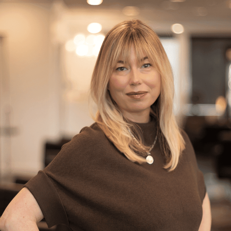 Portrait of Nikki, a professional stylist at Brassfields Salon and Day Spa, showcasing their expertise and style.