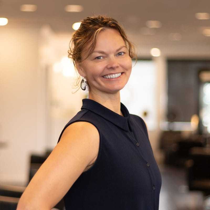 Portrait of Gita, a professional stylist at Brassfields Salon and Day Spa, showcasing their expertise and style.
